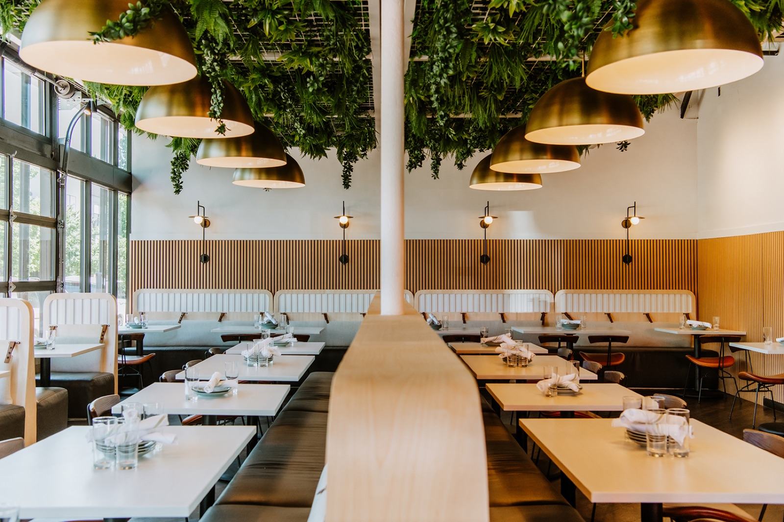 Dining room with brass dome pendants, ceiling-mounted greenery, and wood slat wainscoting — Damn Good Interiors interior design, West Highlands, Denver, CO